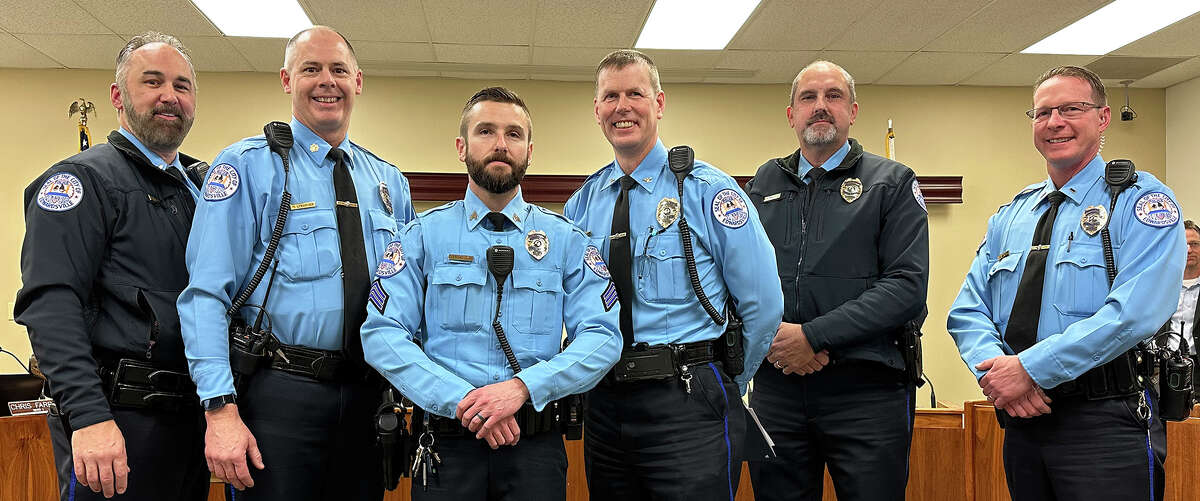 Edwardsville Police Officer Derrick Fitzgerald, third from left, received his promotion to sergeant Tuesday at city council. Police Chief Michael Fillback and Deputy Chief Michael Lybarger were among those who came up to stand with him after he was sworn in.