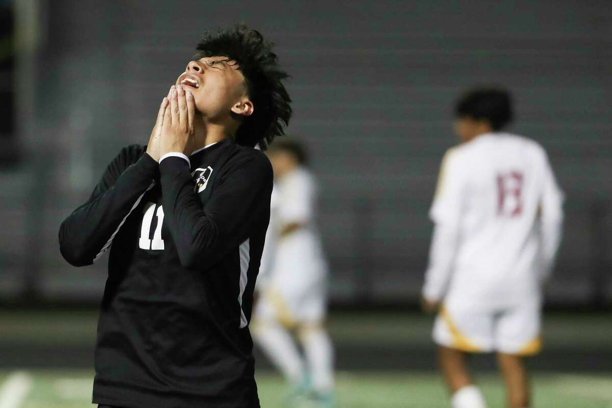 Conroe’s Roger Pioquinto (11) reacts after missing a shot on goal in the first half of a District 13-6A high school soccer match at Buddy Moorhead Stadium, Tuesday, Jan. 17, 2022, in Conroe.
