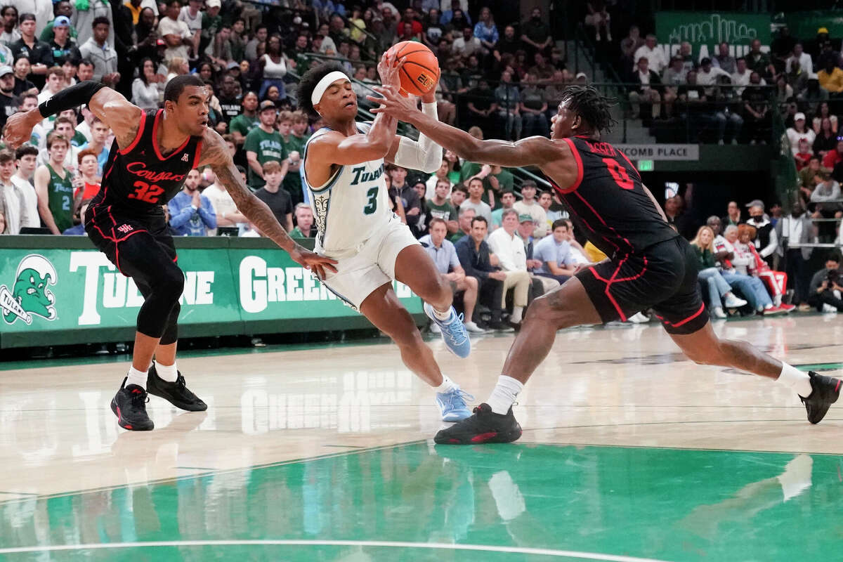 Tulane guard Jalen Cook drives to the basket between UH forward Reggie Chaney, left, and guard Marcus Sasser during the second half of Tuesday night's game in New Orleans.