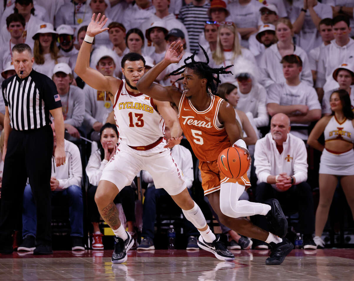 Texas' Marcus Carr drives the ball as Iowa State's Jaren Holmes defends Tuesday night in Ames, Iowa. Carr scored 11 points in a 78-67 loss for the Longhorns.