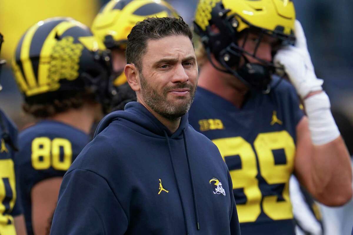 FILE - Michigan co-offensive coordinator and quarterbacks coach Matt Weiss waits for the team's NCAA college football game against Maryland in Ann Arbor, Mich., Sept. 24, 2022. The university has placed Weiss on leave, athletic department spokesman Kurt Svoboda confirmed Tuesday night, Jan. 17. 