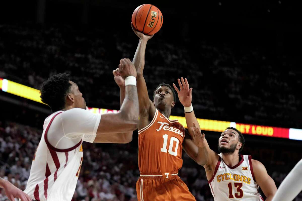 Texas guard Sir'Jabari Rice drives to the basket between Iowa State center Osun Osunniyi, left, and guard Jaren Holmes during the first half Tuesday’s game in Ames, Iowa.
