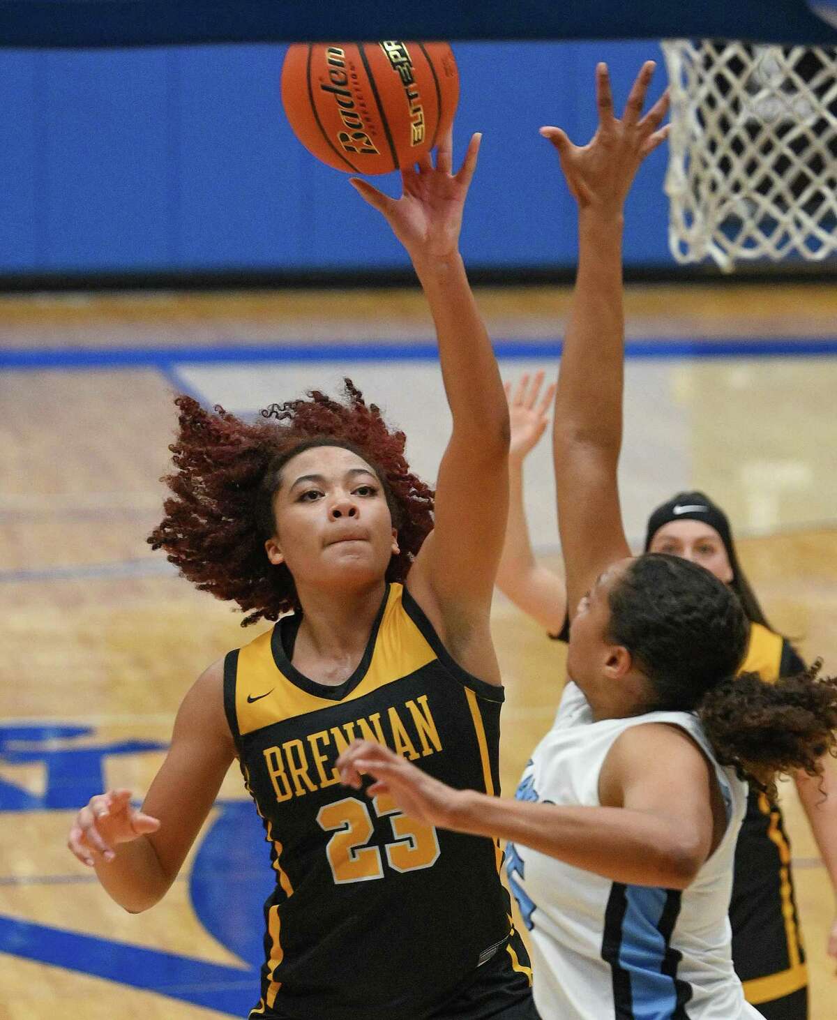 Bella Flemings (23) of Brennan shoots and scores against Harlan during high school girls basketball action at the Northside Sports Gym on Tuesday, Jan. 17, 2023. Brennan won in overtime, 73-71.