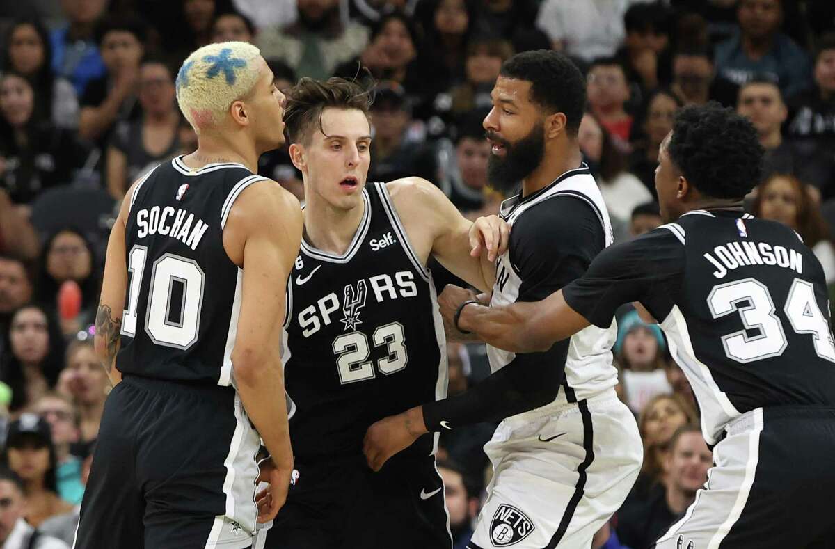 The Spurs’ Jeremy Sochan, left, squares off against the Brooklyn Nets’ Markieff Morris as Zach Collins attempts to intervene after a dustup between Sochan and Morris during their game Tuesday at the AT&T Center.