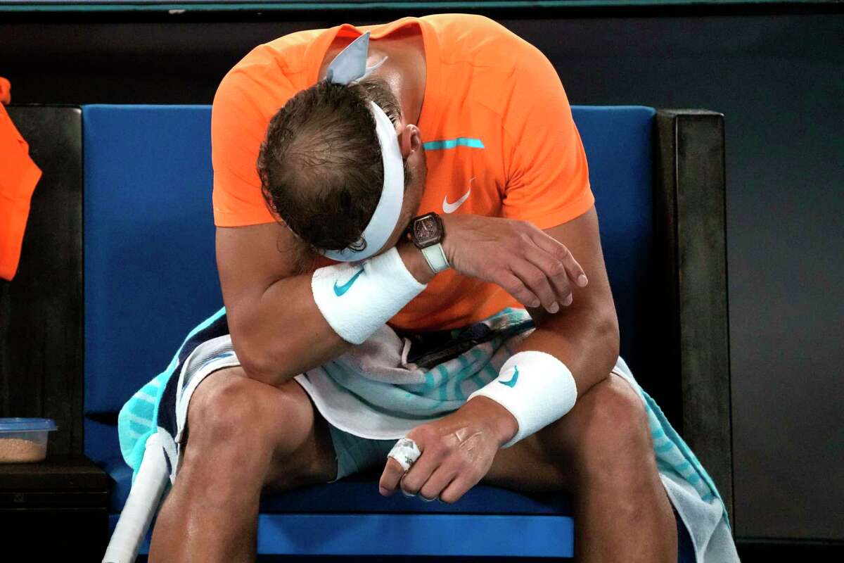 Rafael Nadal of Spain reacts during his second round loss to Mackenzie McDonald of the U.S. at the Australian Open tennis championship in Melbourne, Australia, Wednesday, Jan. 18, 2023. (AP Photo/Dita Alangkara)