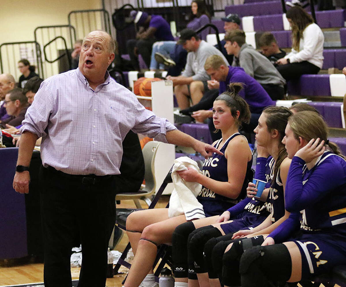 CM coach Mike Arbuthnot glances at the scoreboard while talking to his Eagles during a timeout in a game earlier this season at Mascoutah. On Tuesday, CM lost O'Fallon in a quarterfinal at the Highland Tourney and will play Breese Central in a fifth-place semifinal in Highland on Thursday. 