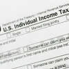 FILE - A portion of the 1040 U.S. Individual Income Tax Return form is shown July 24, 2018, in New York. Taxpayers will get fatter standard deductions for 2023 and all seven federal income tax bracket levels will be revised upward as the government allows people to shield more of their money from taxation because of persistently high inflation. For couples who file jointly for tax year 2023, the standard deduction increases to $27,700 up $1,800 from tax year 2022, the IRS announced. (AP Photo/Mark Lennihan, File)