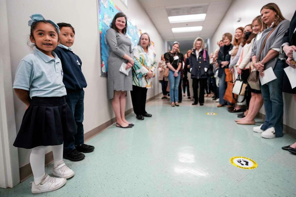 First graders Andrea Hernandez, left, and Emiliano Hernandez speak to members of One Hundred Shares Houston during a tour of San Francisco Nativity Academy on Wednesday, Jan. 18, 2023 in Houston. The group is made up of women who each give $1,000 a year. They then pool the money together to either benefit one or two local ministries, giving a grant of $100,000 or two for $50,000.