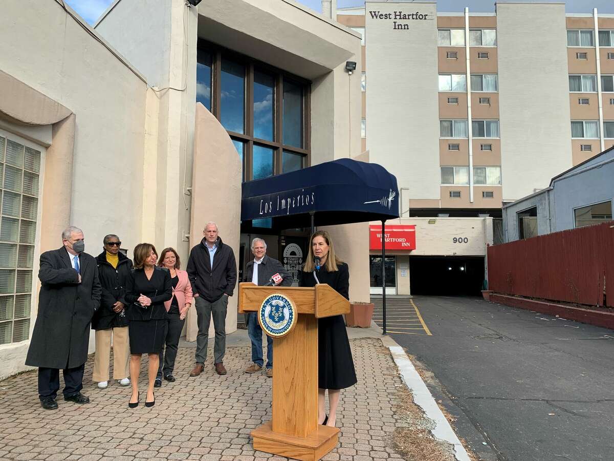 Lt. Gov. Susan Bysiewicz speaks in front of the West Hartford Inn, which developers plan to turn into affordable housing. With Bysiewicz are Mayor Shari Cantor, state Sen. Derek Slap and members of the West Hartford Town Council.