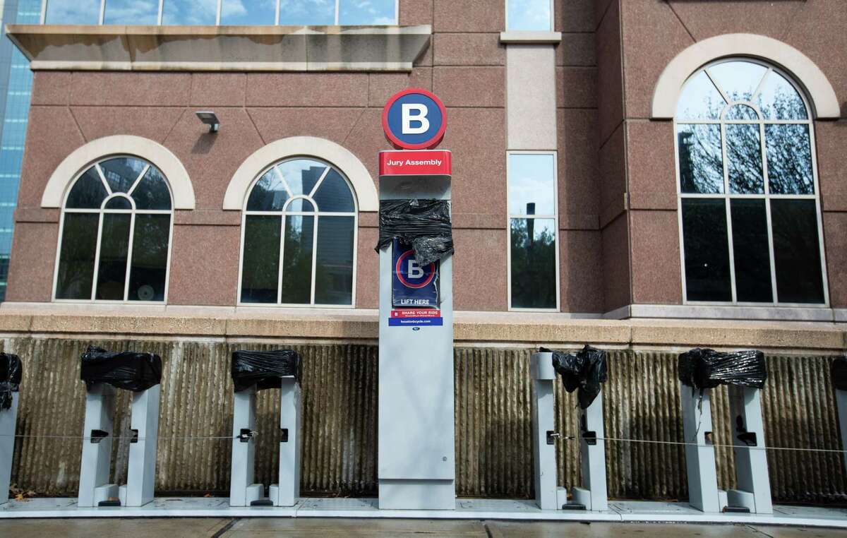 A B-Cycle station outside the Harris County Civil Courthouse is shut down and wrapped in black plastic on Jan. 18, 2023, in Houston. B-Cycle shuttered about half of the 150 stations in the area in November, as part of what they call a cost saving move during winter.