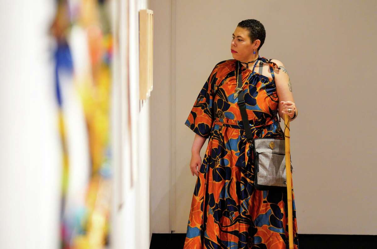 Artist Angela Weddle looks over the public art exhibit titled “Between Yesterday and Tomorrow: Perspectives from Black Contemporary Artists of San Antonio.” The exhibit is on display at the Cultural Commons Gallery located behind City Hall.