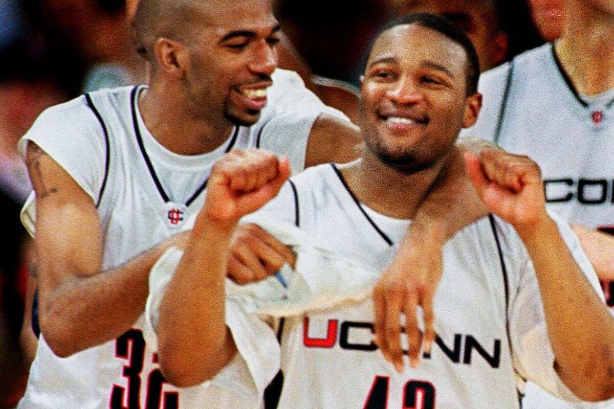 Connecticut guard Richard Hamilton, left and guard Khalid El-Amin, right, celebrate Connecticut's 78-56 win over New Mexico in the second round of the NCAA west regional Saturday, March 13, 1999 in Denver. (AP Photo/David Zalubowski)