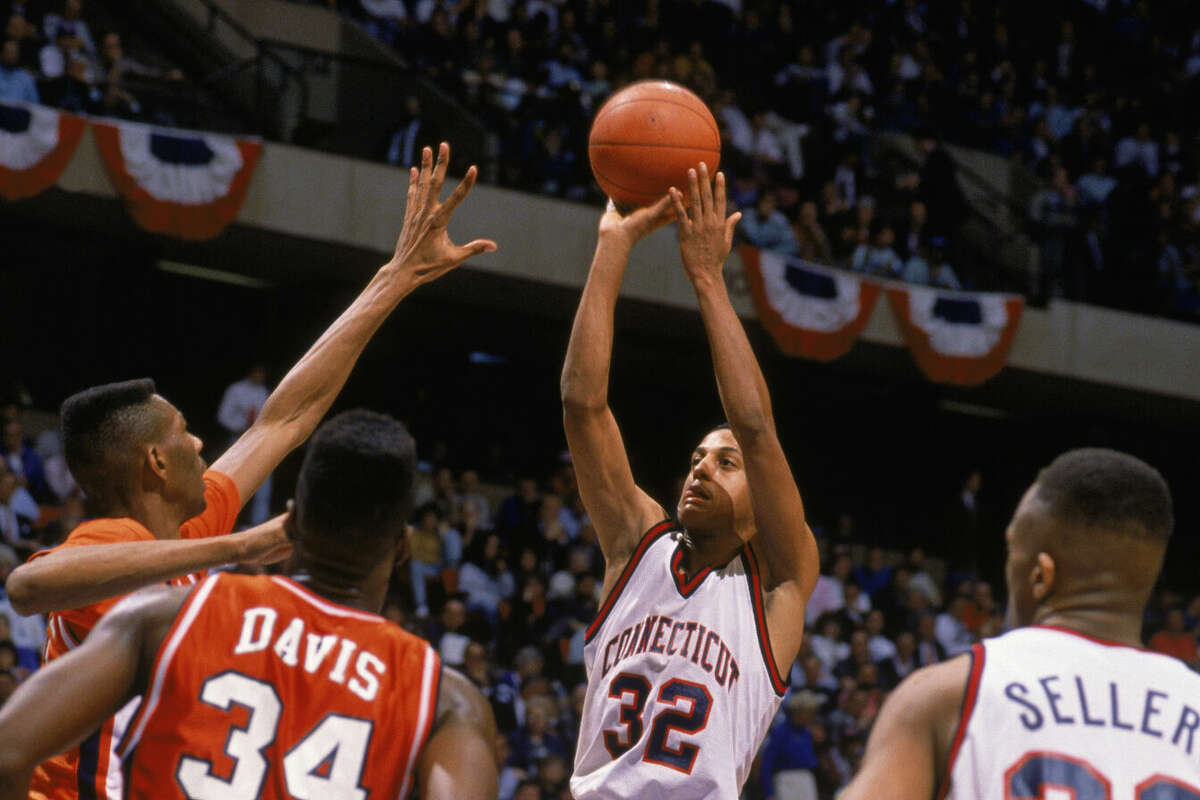 FILE - Tate George #32 of the UConn Huskies puts up a shot during the 1990 "sweet sixteen" NCAA Tournament basketball game against Clemson at the Meadowlands on March 22, 1990 in East Rutherford, New Jersey. As time expires, Tate George's jump shot slips through the rim to give the University of Connecticut Huskies a 71-70 victory over the Clemson Tigers, moving them to the Final Eight for the first time since 1964.