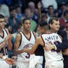 University of Connecticut head coach Jim Calhoun, second from right, hugs Chris Smith as he left the floor at the end of the UConn-University of California game in the second round of the NCAA East regional playoffs, Saturday, March 17, 1990, Hartford, Conn. UConn won the game 74-54 to advance to the quarter-final round. Other team members from left are Scott Burrell, Nadav Henefeld, Tate George and Lyman DePriest.