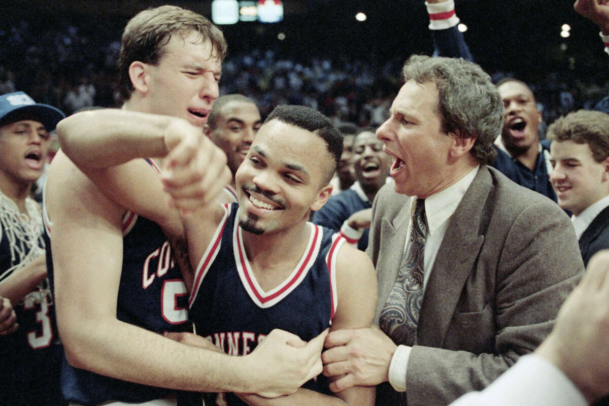 University of Connecticuts Dan Cyrulik, left, Chris Smith, center, and assistant coach Howie Dickeman rejoice after defeating Syracuse University 78-75in Big East action, Sunday, March 11, 1990, New York. Smith won the Most Outstanding Player award in the tournament. (AP Photo/Gerald Herbert)