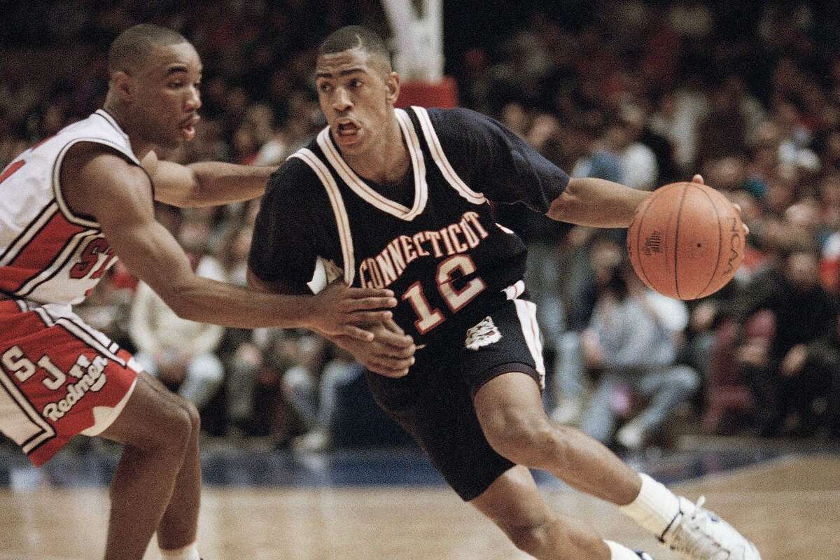 University of Connecticut Huskies Kevin Ollie, right, drives around St. John?s Redmen David Cain during first half Big East action at Madison Square Garden, Jan. 30, 1993 in New York.