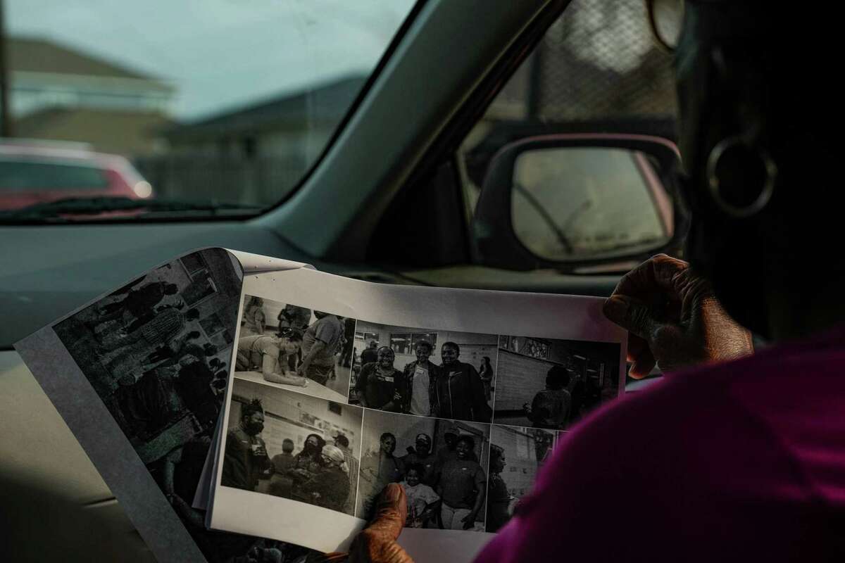 Carolyn Rivera looks at photos of past community meetings she was a part of organizing in the historically black neighborhood of Settegast, which has the lowest life expectancy in all of Harris County on Wednesday, Jan. 18, 2023, in Houston.