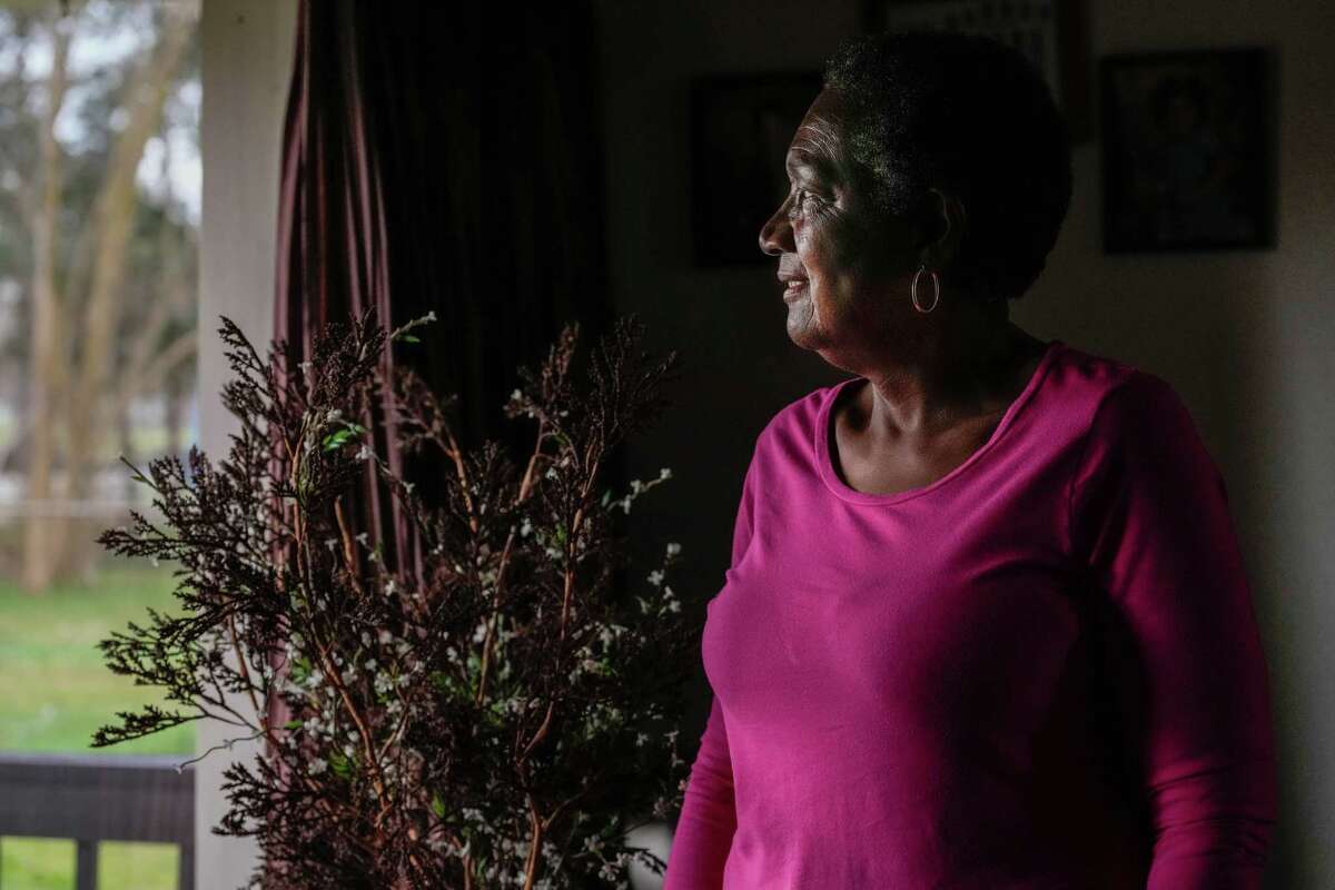 Carolyn Rivera looks out of her home window in the historically black neighborhood of Settegast, which has the lowest life expectancy in all of Harris County on Wednesday, Jan. 18, 2023, in Houston.