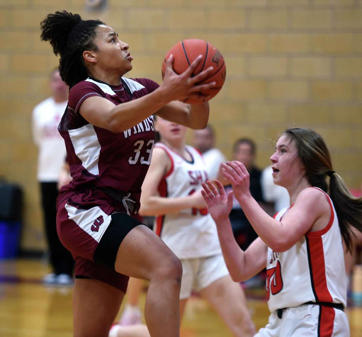 Ayanna Franks of Windsor drives to the basket against Sacred Hearst Academy in the first half in Hamden on January 18, 2023.