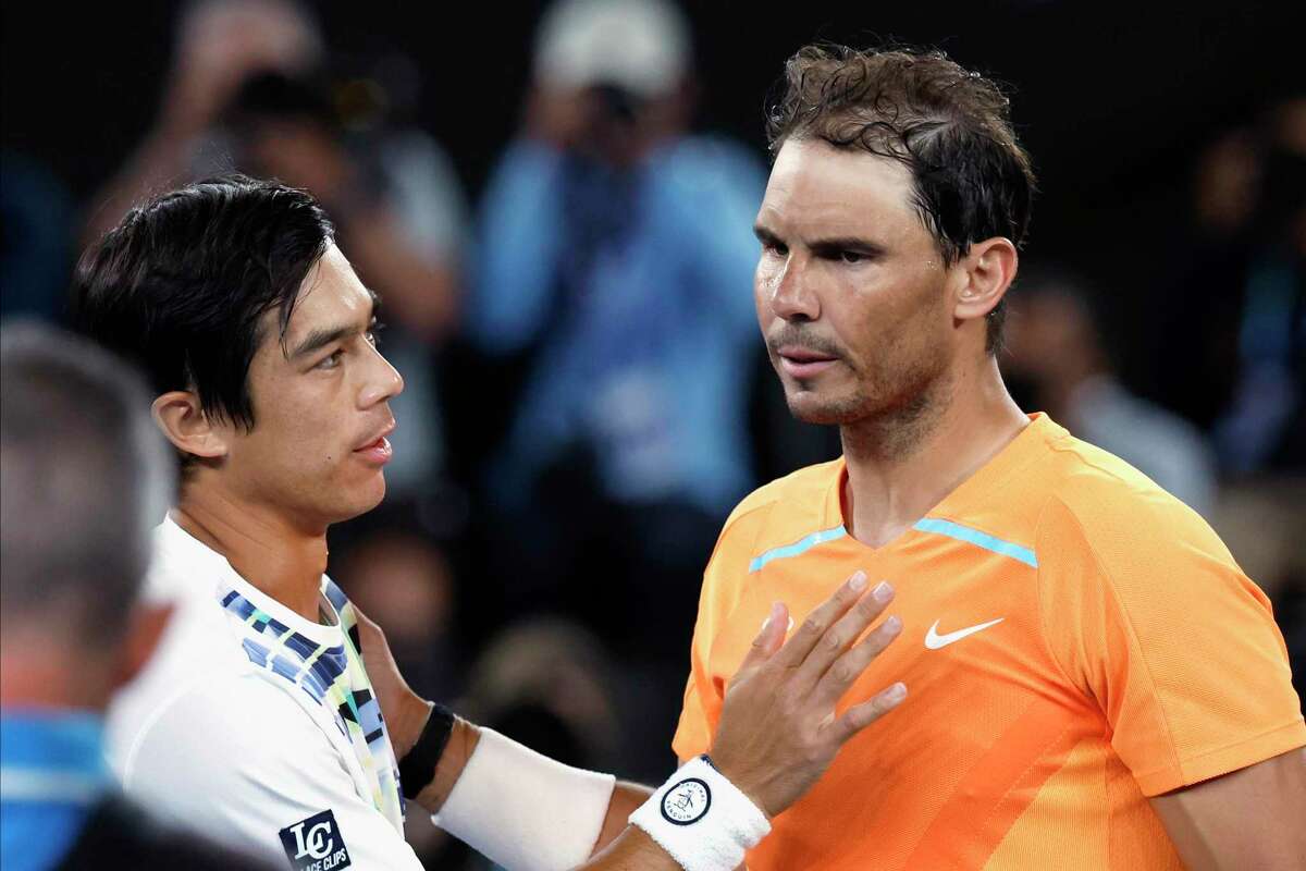 Mackenzie McDonald (left) consoles Rafael Nadal after their match.