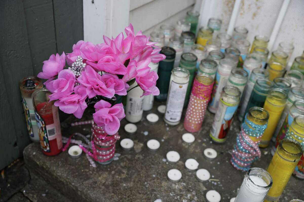 Mourners placed a memorial outside the home where authorities say Paulesha Green-Pulliam killed her two young daughters.