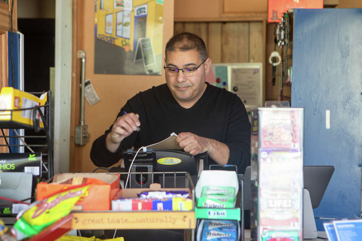 Owner Jesse Ganim works behind the counter at Ganim's Market in the Potrero Hill neighborhood of San Francisco, California on January 12, 2022.