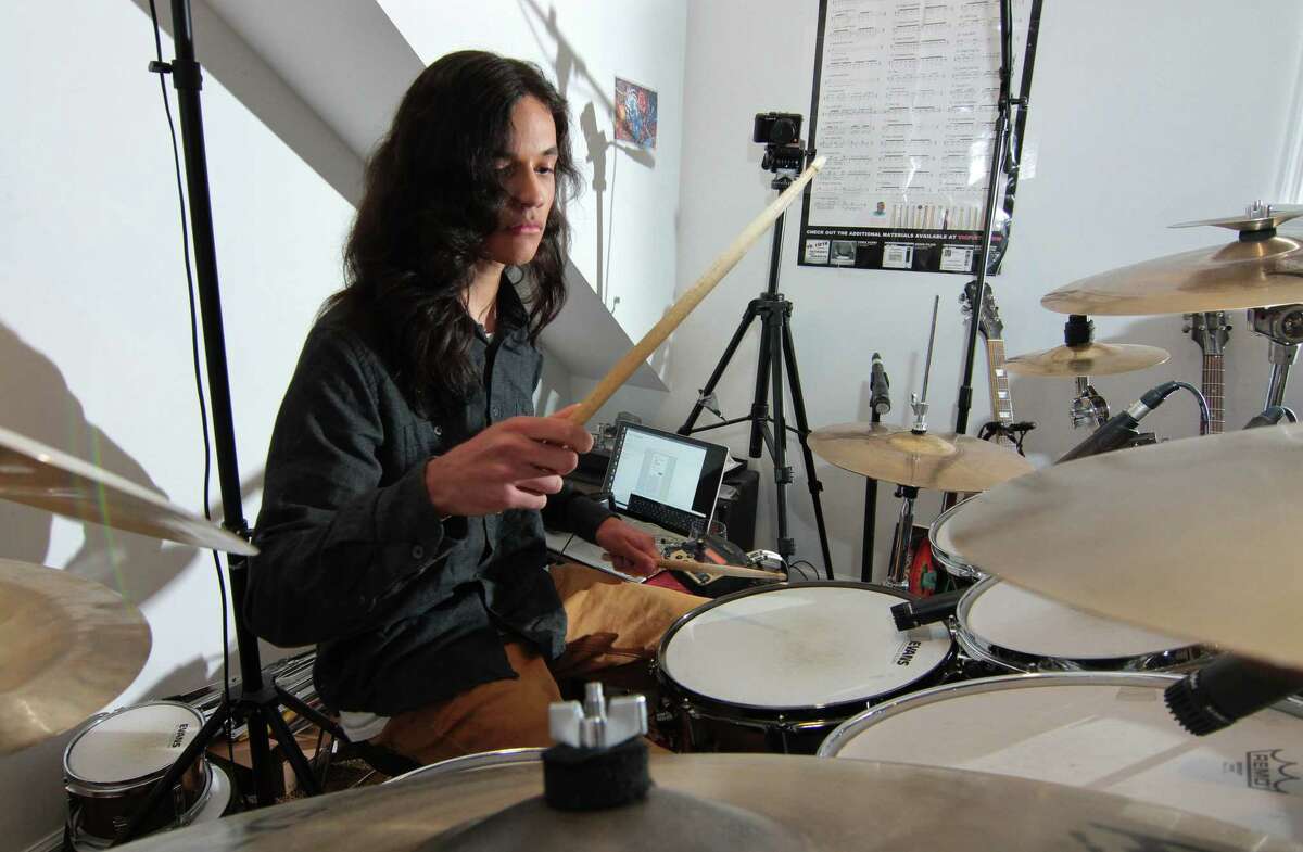 Musician Nikhil Talwalkar, 17, plays drums in his home studio in Darien, Conn., on Wednesday January 18, 2023. Talwalkar's solo album, Reality Drips Into the Mouth of Indifference, landed on Spin Magazine's top ten metal albums of the year alongside genre legends like Ozzy Osbourne.