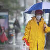 A pedestrian walks down Clement Street during a rainstorm in San Francisco, Calif. on January 11, 2022.