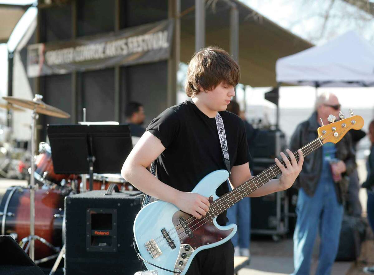 Bassist Dylan Wagner warms up before performing with Jazz Connection The Greater Conroe Arts Festival in downtown Conroe, Saturday, March 19, 2022, in Conroe. The event featured music performances, art vendors, painting demonstrations, and other events.