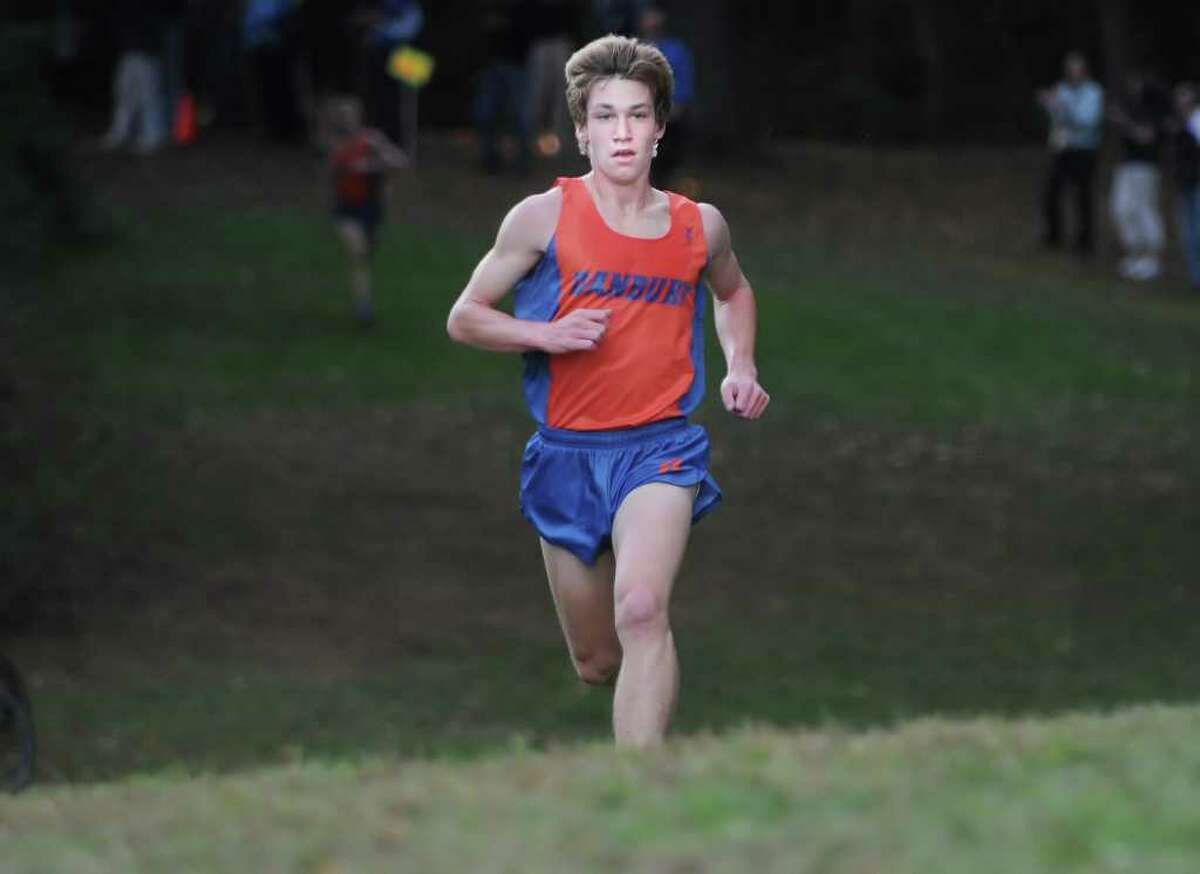 Alex Levine of the Danbury High School cross country team finishes first during meet at Greenwich Point, Tuesday afternoon, Oct. 12, 2010.