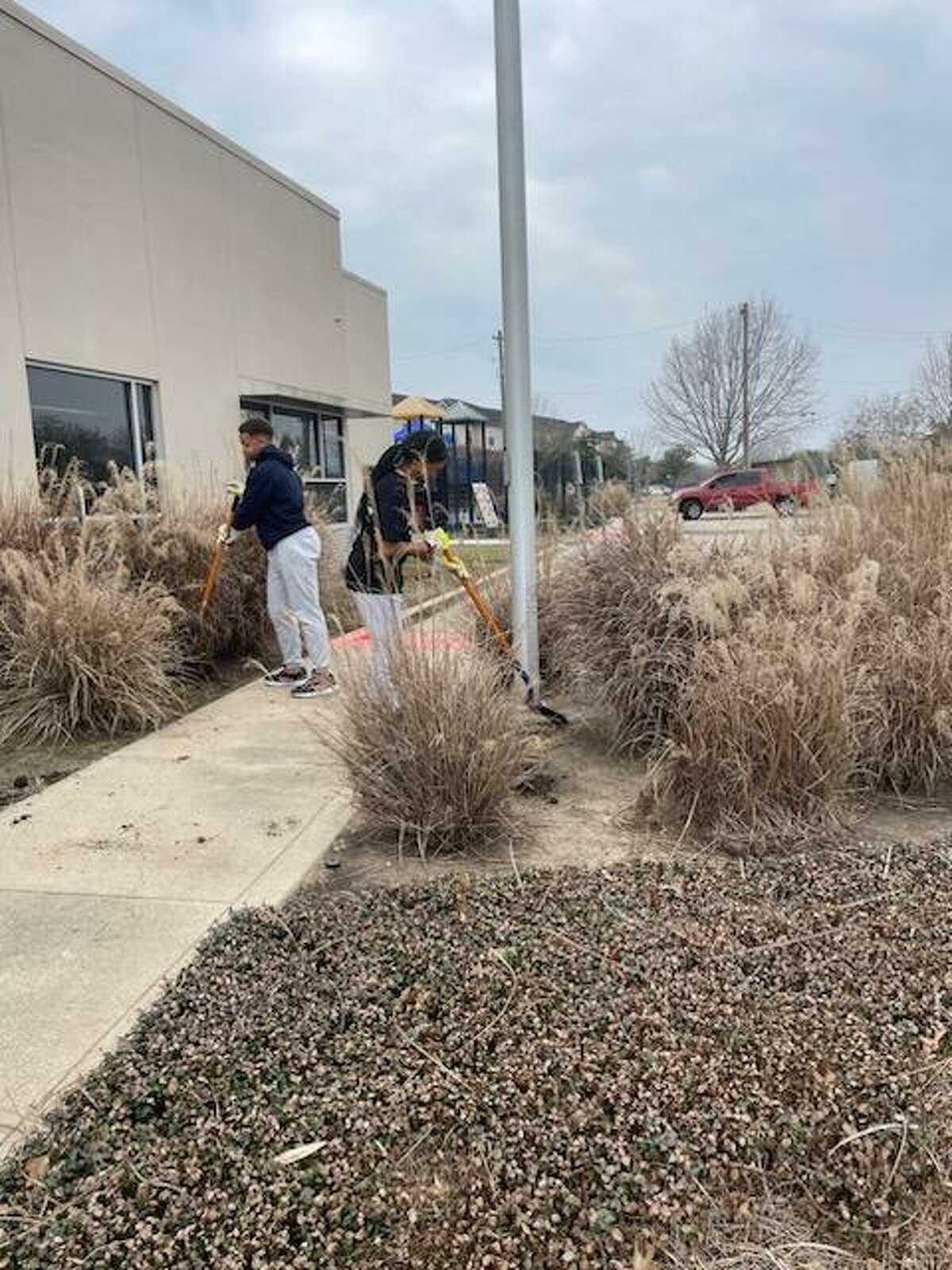 Volunteers cleaned out, weeded, mulched and repaired the area outside the West Orem Family YMCA on Monday. The facility had been closed since March 2020.