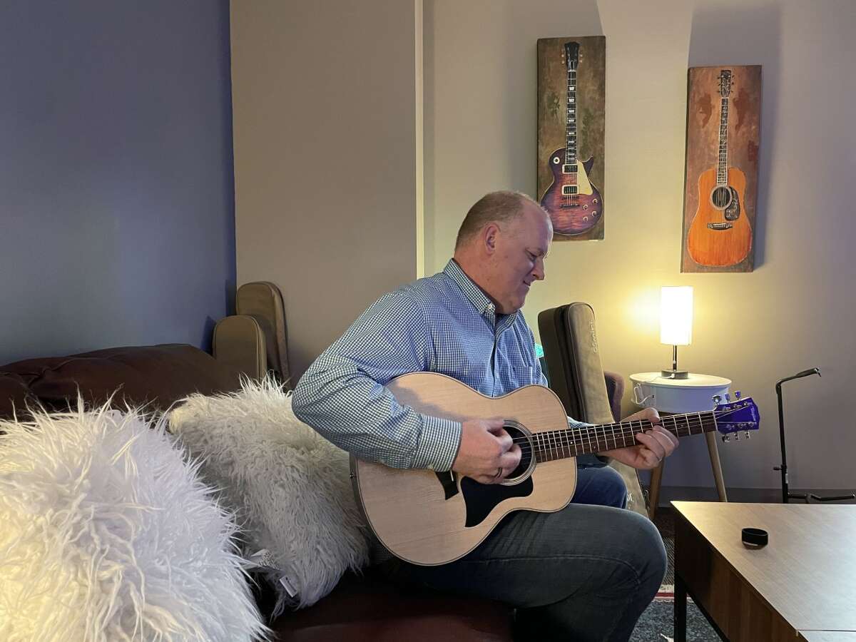 Paul Kwant jamming on guitar inside the new songwriting room he designed for students, which he plans to use for a new club.