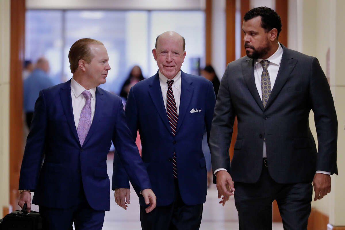 Steven Hotze, center, is flanked by his attorneys as he arrives for an appearance in his criminal case at the Harris County Criminal Courts building on Wednesday, Jan. 11, 2023, in Houston. Hotze denies any wrongdoing. 