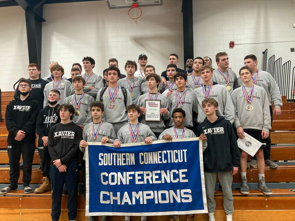 The Xavier wrestling team poses with the  SCC championship banner in February, 2022. The Falcons, the state's top-ranked team, finished third at the War on the Shore in Maryland this weekend.