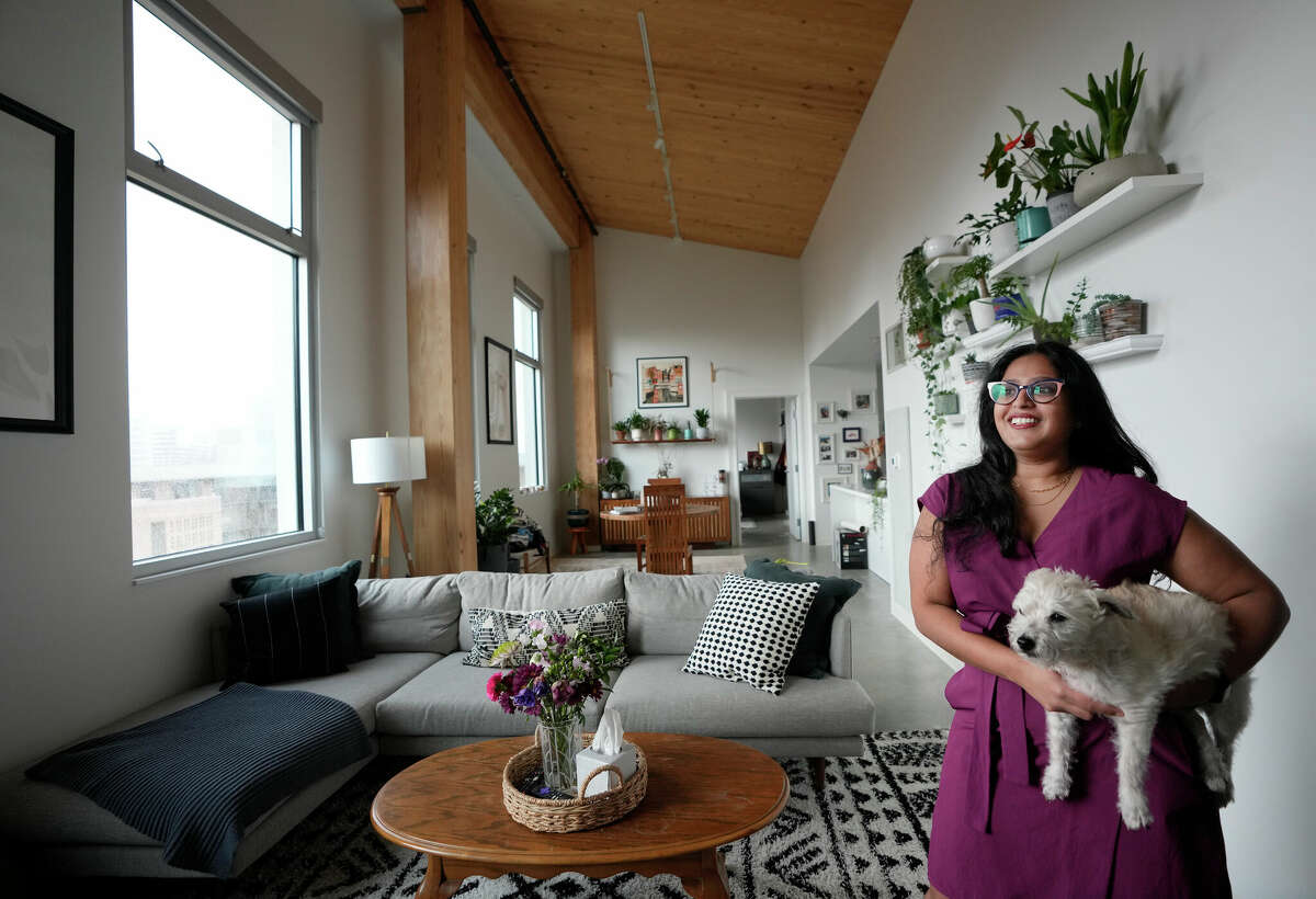 Lebena Varghese, a resident associate, with her dog, Charlie, talks about her suite in the new wing at Hanszen College at Rice University Wednesday, Jan. 18, 2023, in Houston. It was built using cross-laminated timber, a first for a residential building on a university campus in Texas.