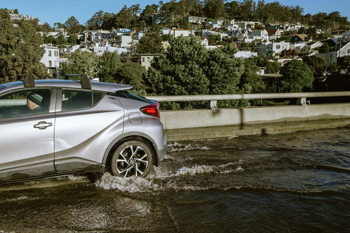Cars attempting to drive through the flooded Monterey exit off the 280 highway towards Glenn Park District in San Francisco, Calif., on Sunday, Jan. 1st, 2022.