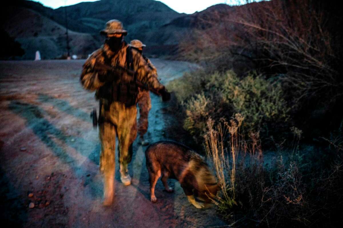 Members of the Constitutional Patriots New Mexico Border Ops Team militia, Viper and Stinger who go by aliases to protect their identity, patrol the US-Mexico border in Sunland Park, New Mexico on March 20, 2019. The militia members say they will patrol the US-Mexico border near Mt. Christo Rey, "Until the wall is built." 