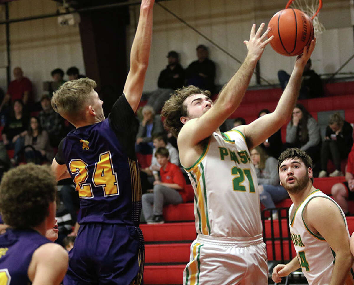 Southwestern's Hank Bouillon (21) gets past Mount Olive's Blake Dickerson for a shot in a Macoupin County Tournament game earlier this week at Hlafka Hall in Bunker Hill.