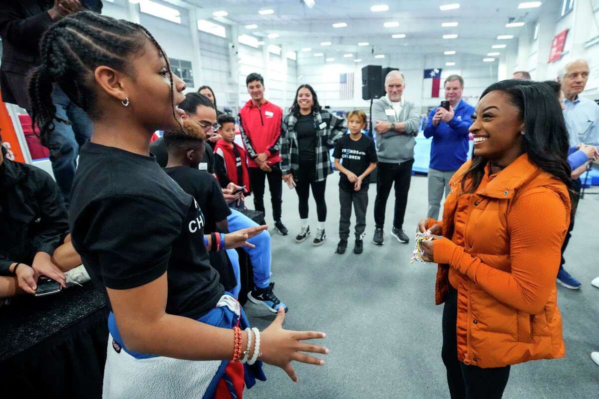 Olympic gold medalist Simone Biles, right, talks to Mariah Haynes after Haynes gave her a hand-made bracelet following a question and answer session with kids from Friends of the Children as she revealed her second Wheaties limited-edition box cover on Thursday, Jan. 19, 2023 in Spring. Friends of the Children is a national nonprofit committed to ongoing mentorship of youth, which will open a chapter in the Houston area this year.