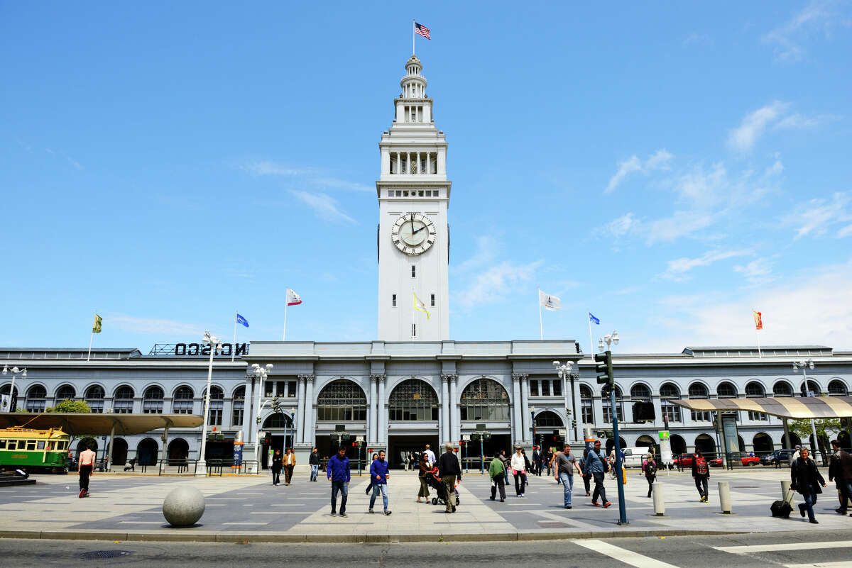People walk along the Embarcadero outside San Francisco's Ferry Building. The landmark is undergoing renovations later this year. 