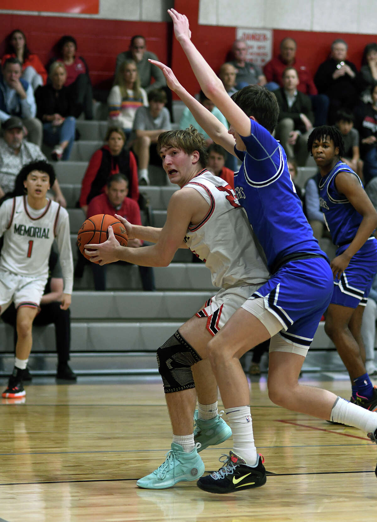 Memorial senior Caleb Sanders, left, feels the defensive pressure from Cy Creek 6'7" senior Noah Martin during aciton in the third quarter of their District 17-6A matchup at Memorial High School on Jan. 18, 2023.