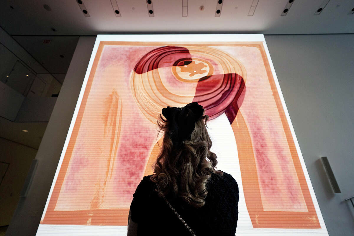 A visitor looks at artist Refik Anadol's "Unsupervised" exhibit at the Museum of Modern Art in New York.