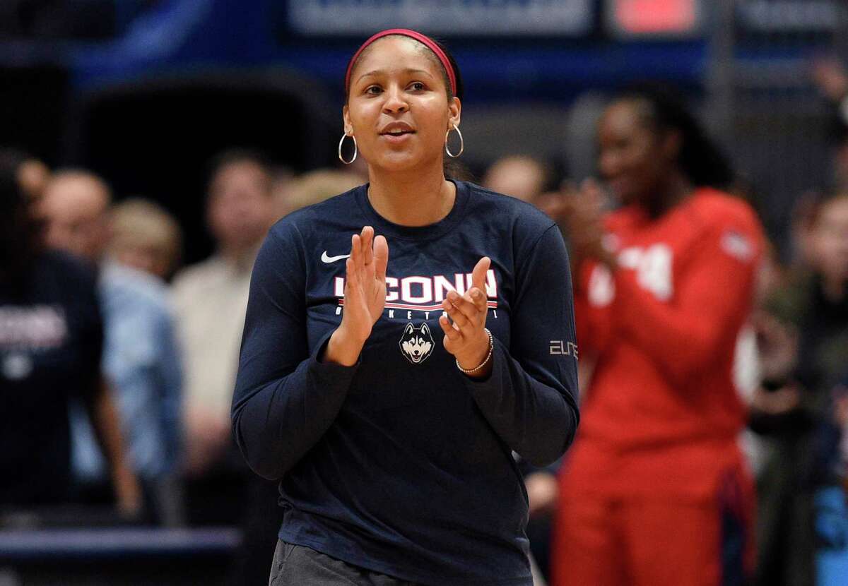 In this Jan. 27, 2020, file photo, former Connecticut and Minnesota Lynx player Maya Moore applauds in Hartford. Moore left the WNBA in 2019 to help her now husband Jonathan Irons get his conviction overturned and win his release from prison. She recently retired from professional basketball.