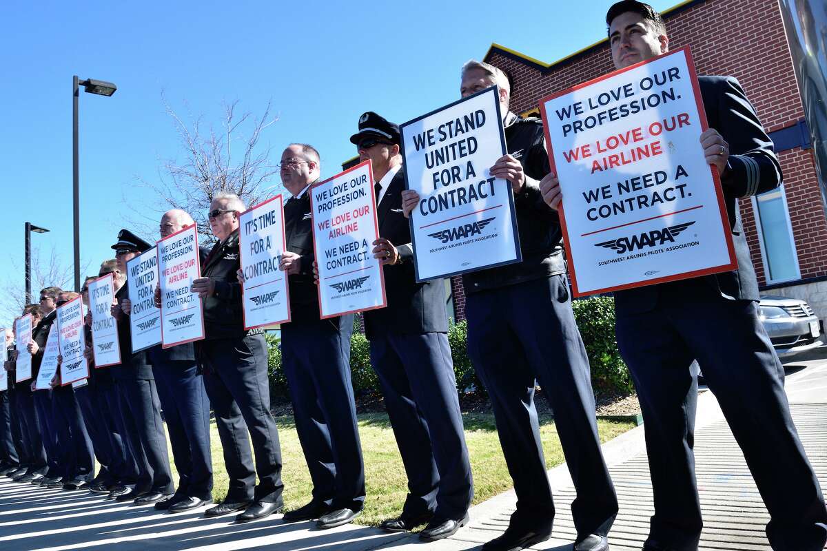 About 100 Southwest Airlines pilots silently protest in support of a contract outside Love Field in Dallas in 2022.