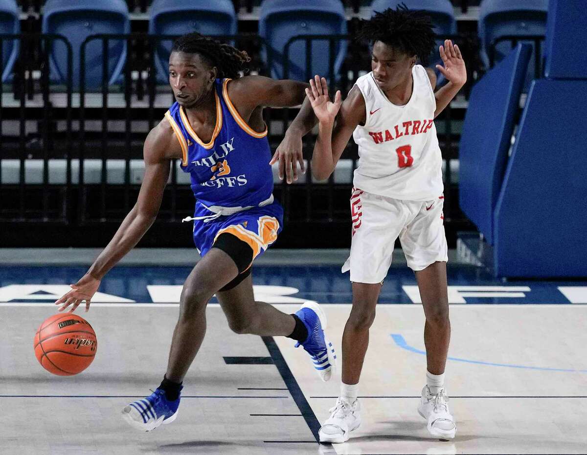 Milby guard Kemoriay Thomas, left, dribbles past Waltrip guard Jacori Miles during the second half of a high school basketball game, Thursday, Jan. 19, 2023, in Houston.