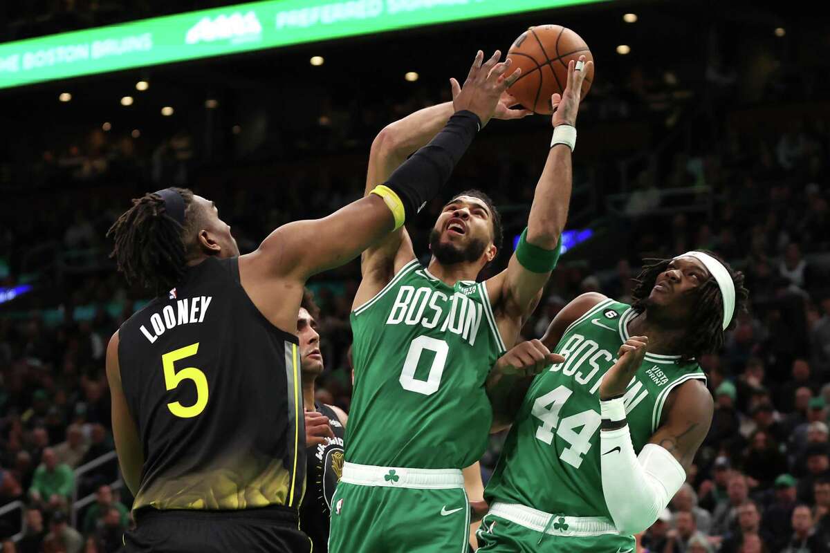BOSTON, MASSACHUSETTS - JANUARY 19: Jayson Tatum #0 of the Boston Celtics takes a shot against Kevon Looney #5 of the Golden State Warriors during the first half at TD Garden on January 19, 2023 in Boston, Massachusetts. NOTE TO USER: User expressly acknowledges and agrees that, by downloading and or using this photograph, User is consenting to the terms and conditions of the Getty Images License Agreement. (Photo by Maddie Meyer/Getty Images)