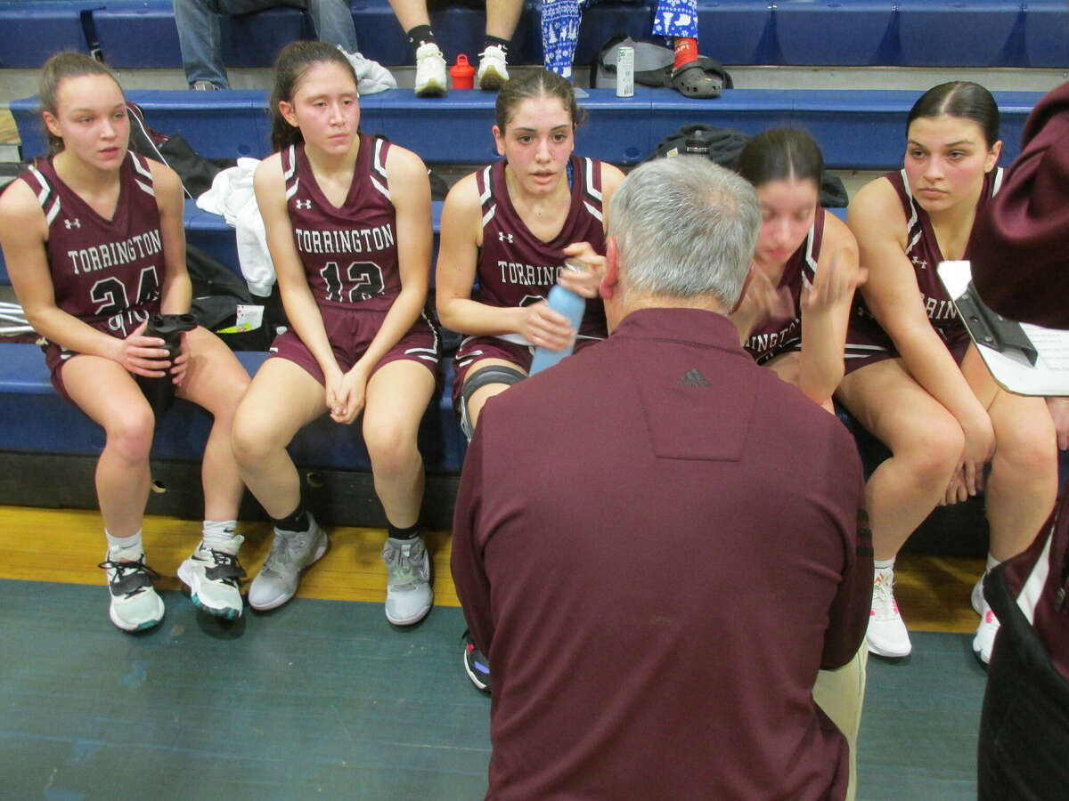 Torrington's starting lineup pays attention to Coach Mike Fritch in a win over the Yellowjackets at The Gilbert School Thursday night.