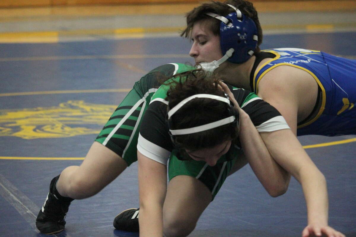 Evart's Alannah Bentley (top) maneuvers against Houghton Lake's Cora Marcotte during Thursday wrestling action. Bentley took an 11-2 decision.