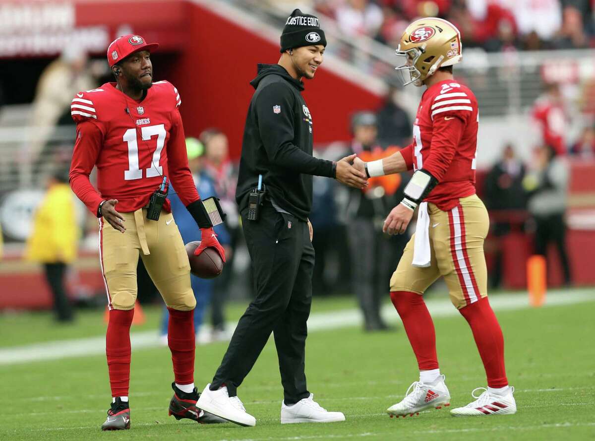 San Francisco 49ers’ Trey Lance and Josh Johnson greet Brock Purdy after a Purdy TD pass during 35-7 win over Tampa Bay Buccaneers in NFL game at Levi’s Stadium in Santa Clara, Calif., on Sunday, December 11, 2022.
