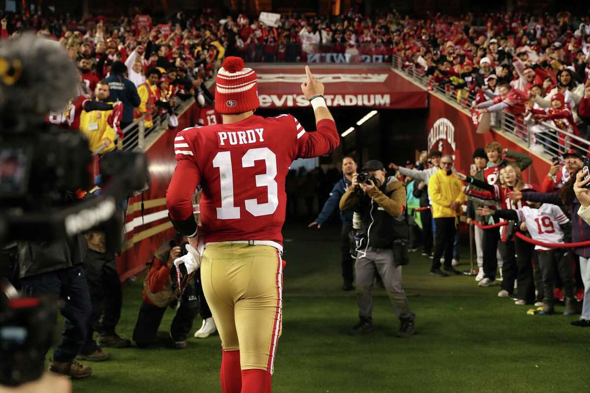 San Francisco 49ers’ Brock Purdy runs off the field after Niners’ 41-23 win over Seattle Seahawks in NFC Wild Card Playoffs in Santa Clara, Calif., on Saturday, January 14, 2023.